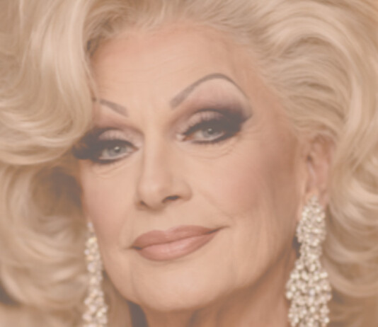 Grand Dame: Episode 6 – “The One Man I Never Outgrew” Close-up portrait of a glamorous older woman with platinum blonde hair and diamond earrings.