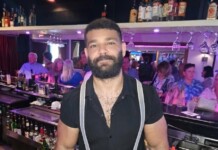 Hot Bartender – Mohammad Balaoni Bearded bartender wearing a black shirt and suspenders behind a busy bar.