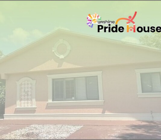 Small single-story house with light trim and a Pride House logo in the top-right corner.