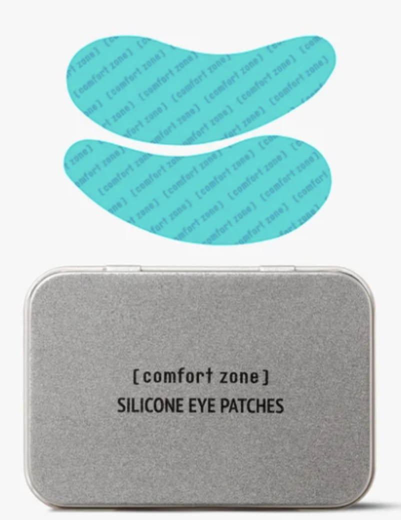 Silver tin labeled '[comfort zone] SILICONE EYE PATCHES' with two curved blue silicone eye patches above the tin, shown as a skincare product photo.