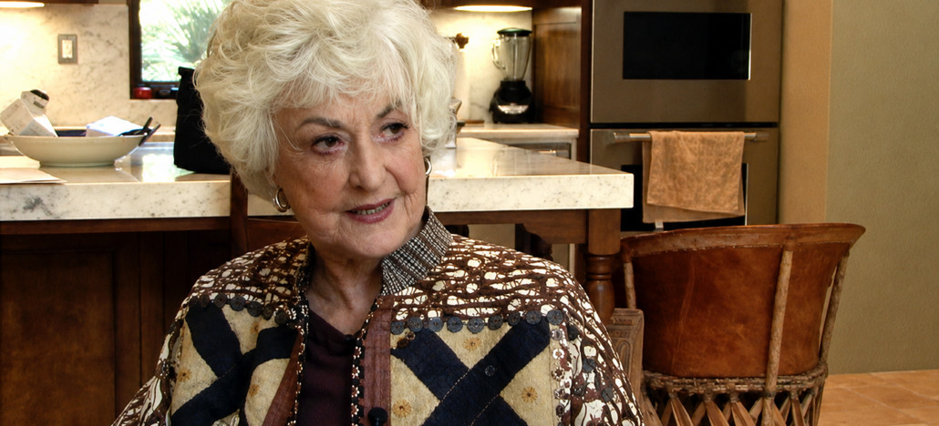 Outshine Film Festival’s Fall Edition – Fort Lauderdale and Miami from Oct 15-25 | Hotspots Magazine Hotspots Magazine Portrait of an elderly woman with white hair wearing a patterned cardigan, seated in a kitchen near a marble countertop.