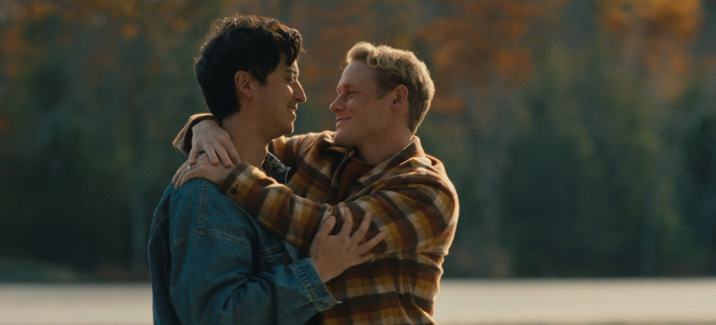 Outshine Film Festival’s Fall Edition – Fort Lauderdale and Miami from Oct 15-25 | Hotspots Magazine Hotspots Magazine Two men embrace and smile at each other by a lake with autumn trees in the background, wearing casual jackets.